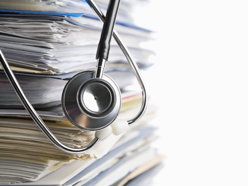 Stethoscope on a pile of medical records